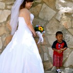 A bride and a little boy. Not sure if she knew him but he was fascinated with her.
