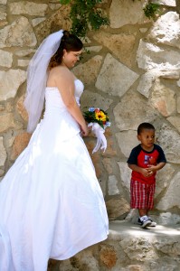 A bride and a little boy. Not sure if she knew him but he was fascinated with her.